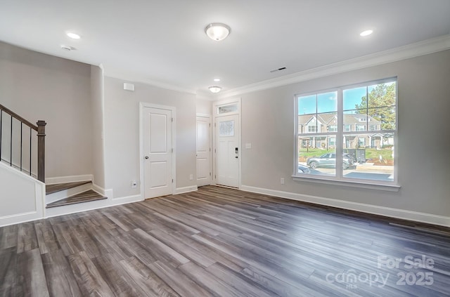 foyer featuring baseboards, stairs, ornamental molding, and dark wood-type flooring