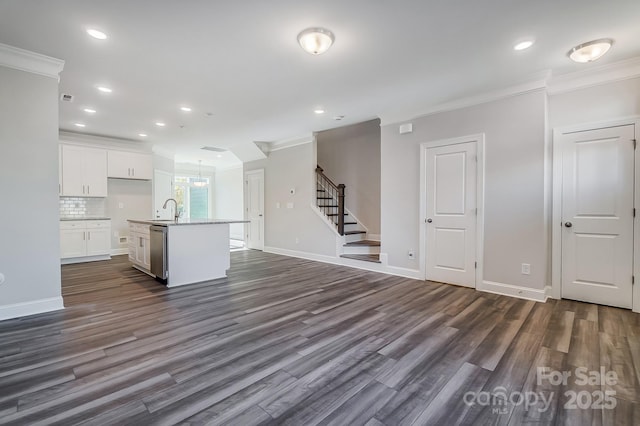 kitchen with white cabinetry, open floor plan, light countertops, dishwasher, and an island with sink