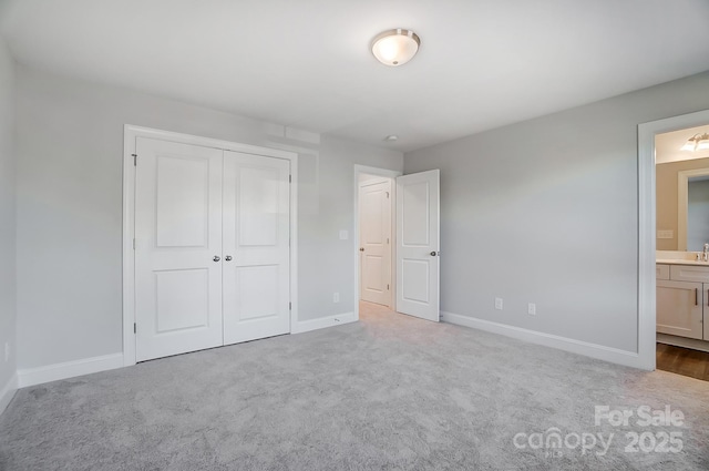 unfurnished bedroom with baseboards, a closet, and light colored carpet