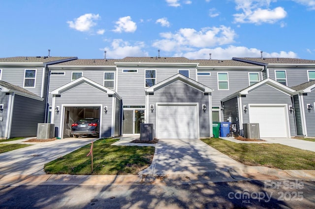 townhome / multi-family property featuring a garage, driveway, and a residential view