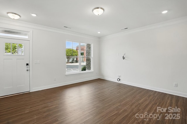 entryway with a wealth of natural light, crown molding, visible vents, and baseboards