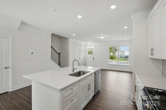 kitchen with crown molding, a sink, light countertops, appliances with stainless steel finishes, and dark wood-style floors