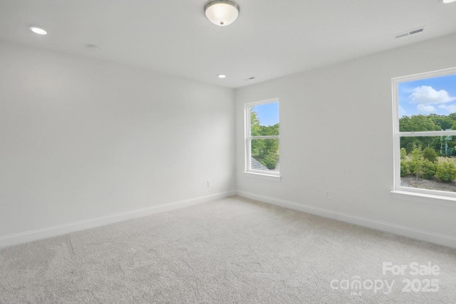 empty room featuring recessed lighting, visible vents, baseboards, and light colored carpet
