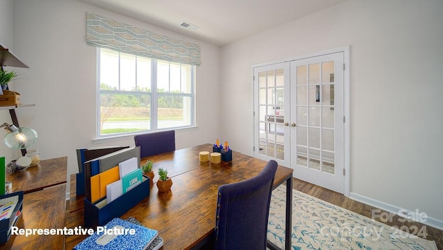 dining room with wood-type flooring and french doors