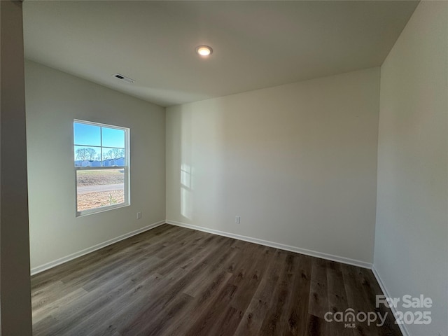 empty room featuring dark wood-type flooring