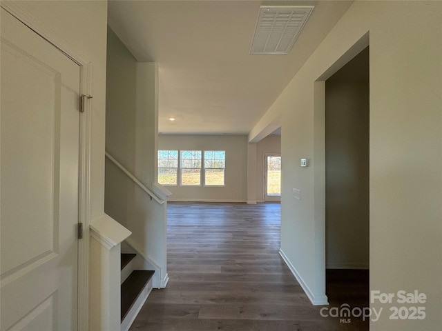 hallway with dark hardwood / wood-style flooring