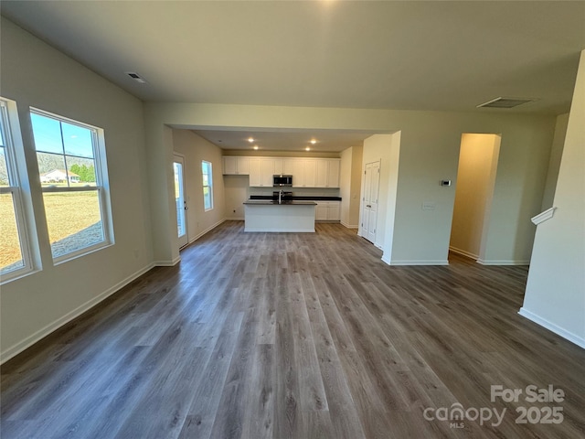 unfurnished living room with wood-type flooring