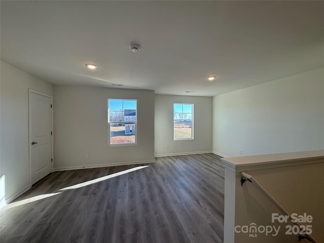 spare room featuring dark wood-type flooring