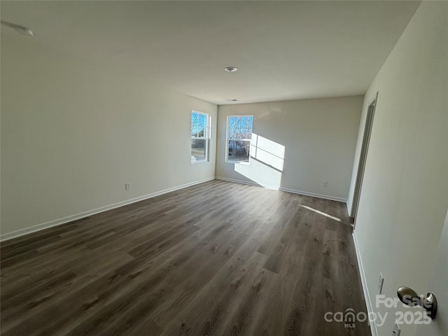 spare room with dark hardwood / wood-style floors