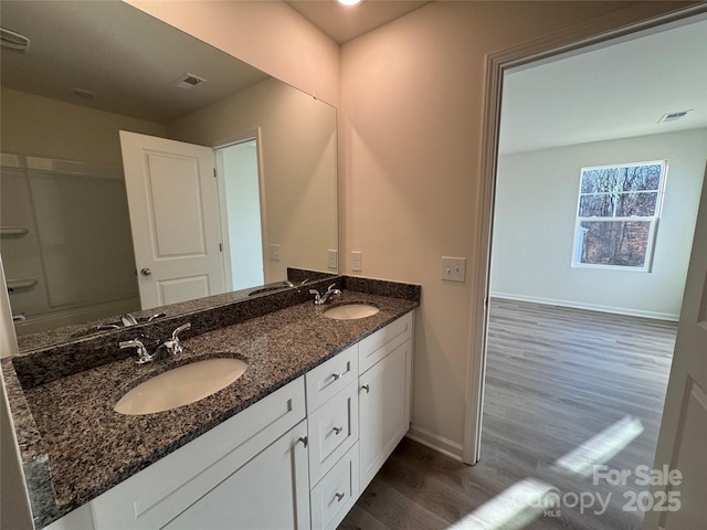 bathroom featuring vanity and hardwood / wood-style flooring