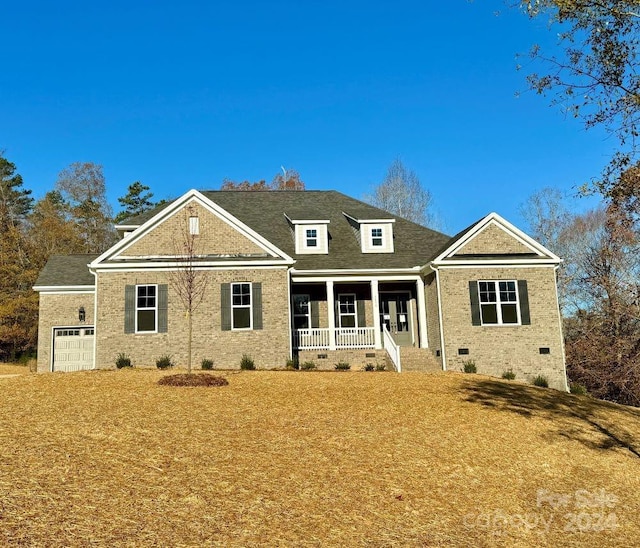 view of front of house featuring a porch and a garage