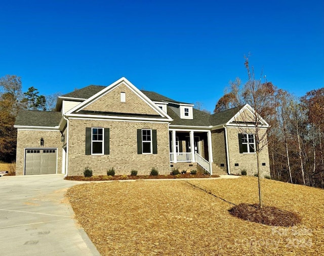 view of front of home featuring a porch and a garage