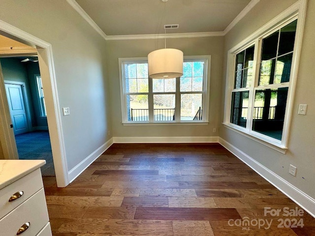 unfurnished dining area with dark hardwood / wood-style flooring and ornamental molding