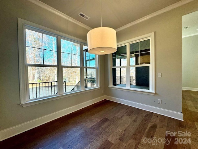 unfurnished dining area featuring dark hardwood / wood-style flooring and ornamental molding