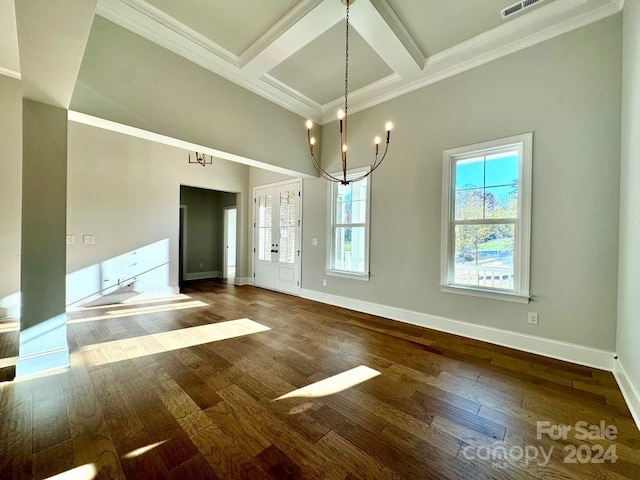 unfurnished dining area with coffered ceiling, dark hardwood / wood-style floors, ornamental molding, a notable chandelier, and beam ceiling