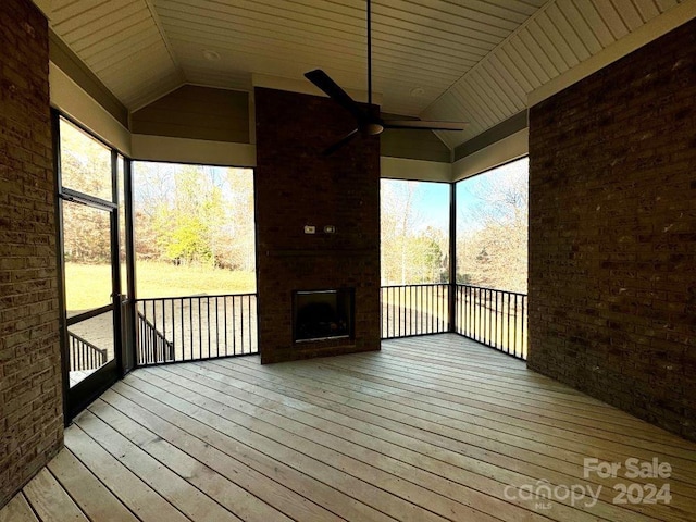 wooden deck with ceiling fan and a fireplace