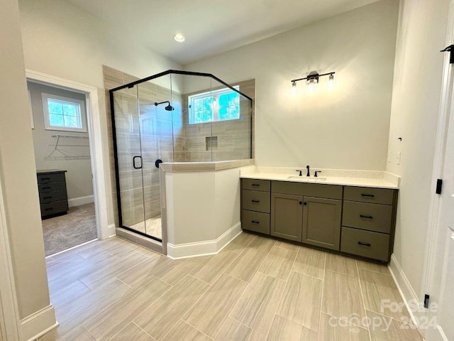 bathroom featuring vanity and an enclosed shower