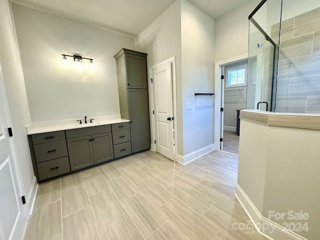 bathroom featuring vanity and a shower with shower door