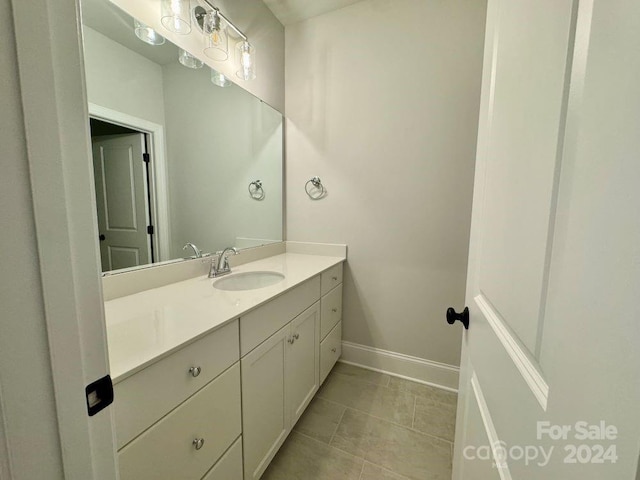 bathroom featuring tile patterned flooring and vanity