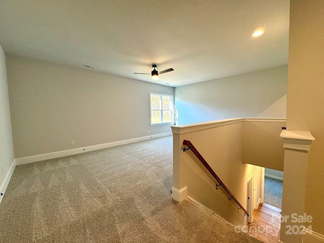 interior space with carpet and ceiling fan