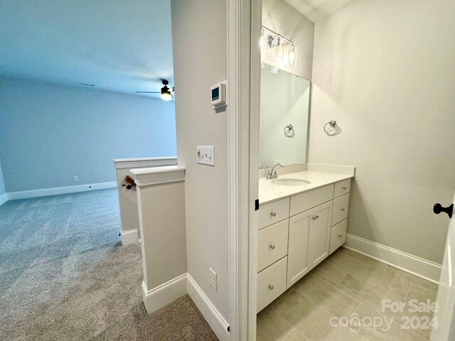 bathroom with ceiling fan and vanity