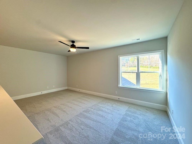 empty room with light carpet and ceiling fan