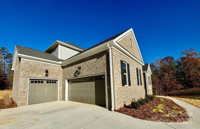 3850 Willow Grove Ln Unit 24, Concord, NC 28025 - view of home's exterior featuring a garage, driveway, and brick siding