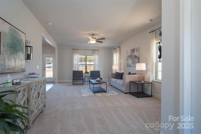 living room featuring light carpet and ceiling fan