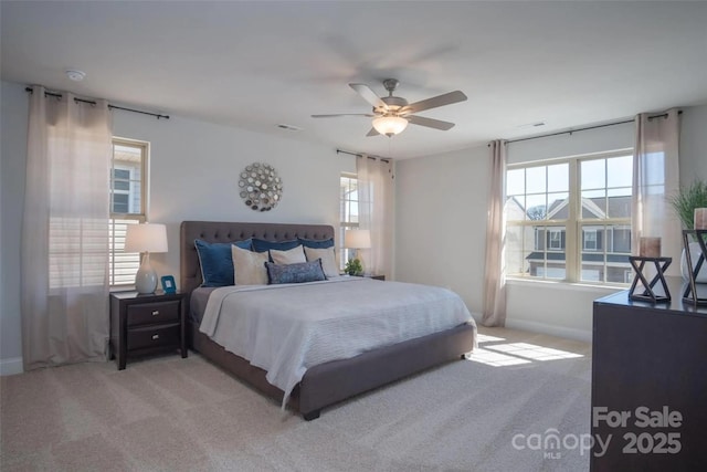 bedroom with ceiling fan and light carpet