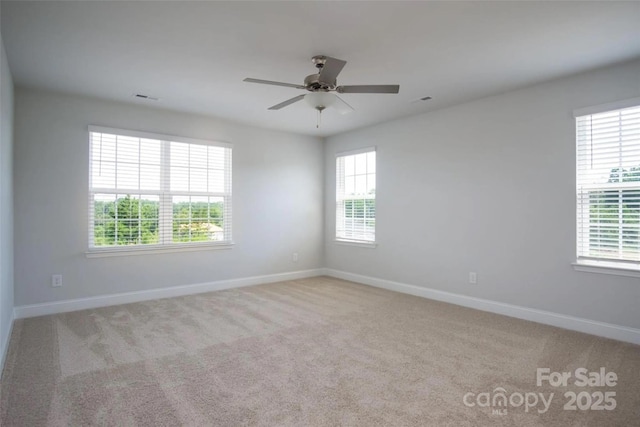 empty room featuring light carpet and ceiling fan