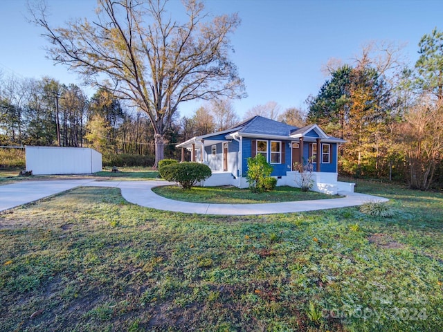 exterior space featuring a yard and an outdoor structure