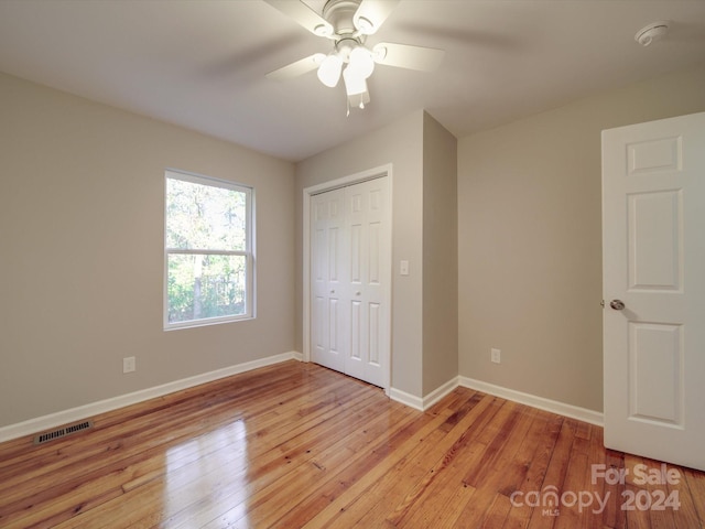 unfurnished bedroom featuring a closet, ceiling fan, and light hardwood / wood-style flooring