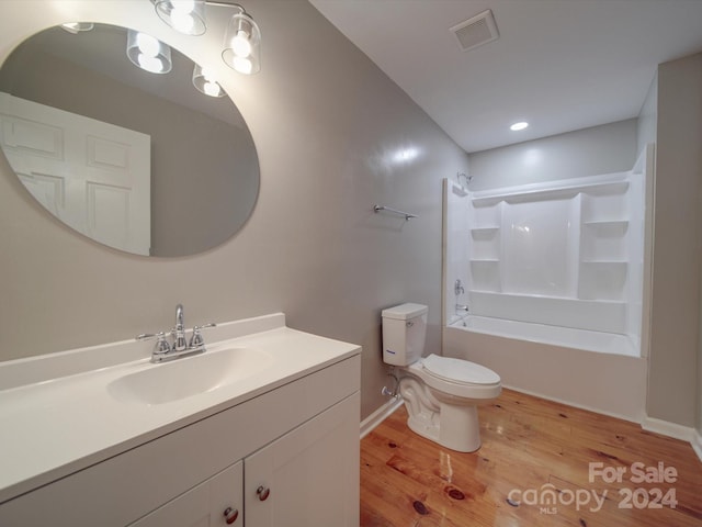 full bathroom featuring vanity, toilet, wood-type flooring, and shower / washtub combination