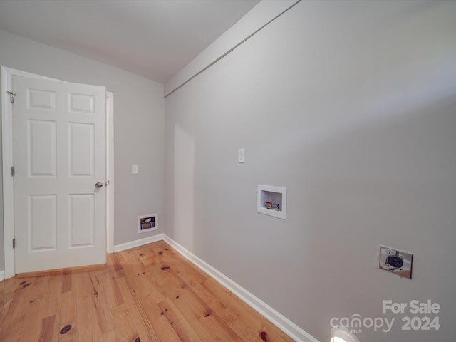 clothes washing area featuring hookup for a washing machine, light hardwood / wood-style flooring, and hookup for an electric dryer