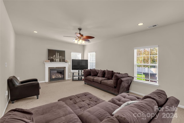 carpeted living room featuring ceiling fan