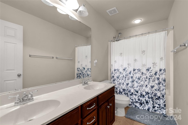 bathroom featuring tile patterned floors, a shower with curtain, vanity, and toilet