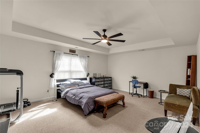 bedroom with carpet, a raised ceiling, and ceiling fan