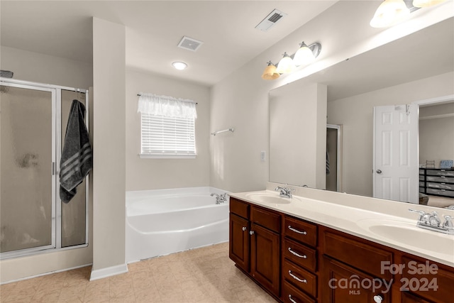 bathroom with vanity and independent shower and bath