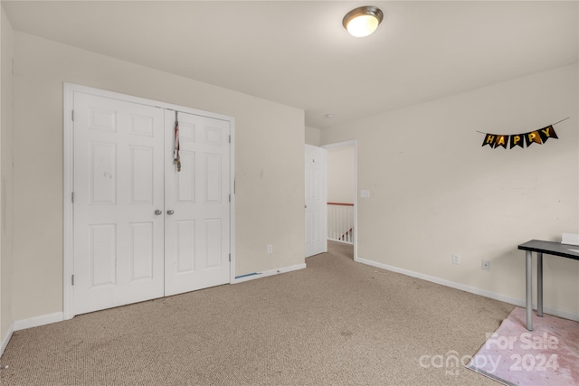 unfurnished bedroom featuring a closet and carpet floors