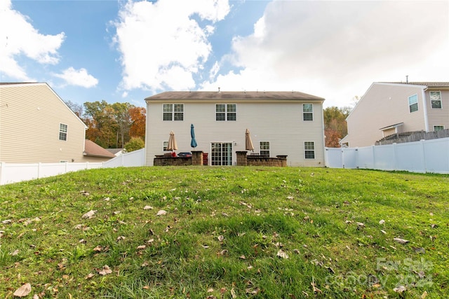 rear view of property featuring a yard