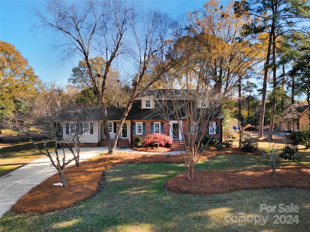 new england style home featuring a front lawn