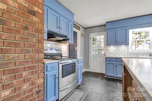 kitchen featuring blue cabinetry, dark tile patterned floors, a textured ceiling, stainless steel electric stove, and decorative backsplash