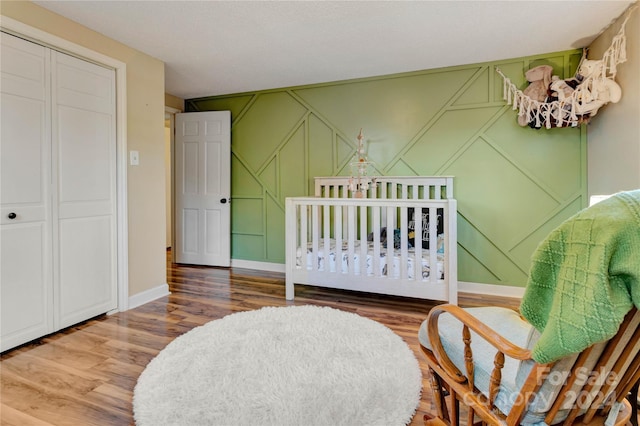 bedroom featuring hardwood / wood-style floors and a closet