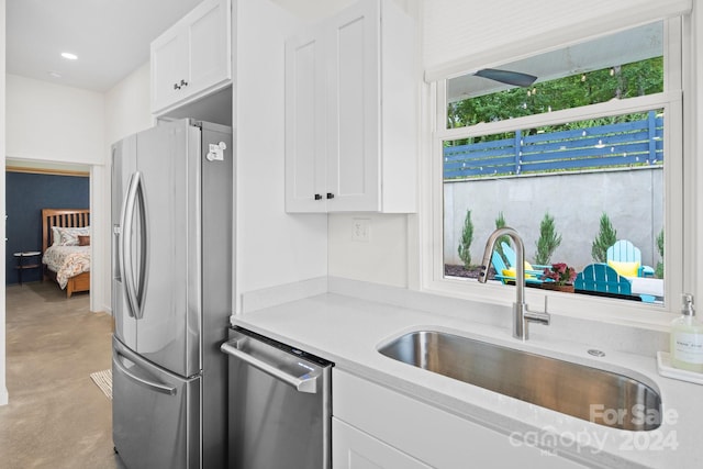 kitchen with white cabinets, sink, and stainless steel appliances