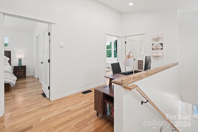 interior space featuring light wood-type flooring and lofted ceiling