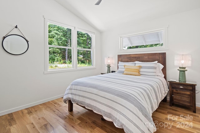 bedroom featuring ceiling fan, hardwood / wood-style floors, and lofted ceiling