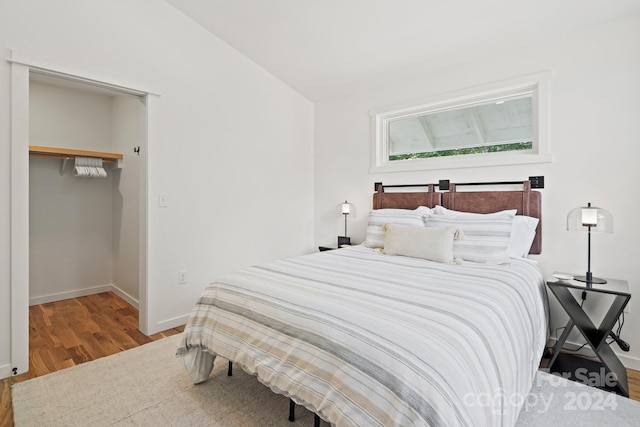 bedroom with hardwood / wood-style floors and a closet