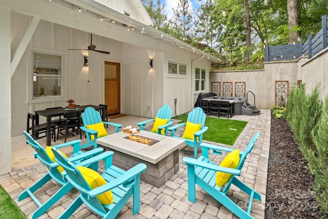 view of patio with an outdoor fire pit and ceiling fan