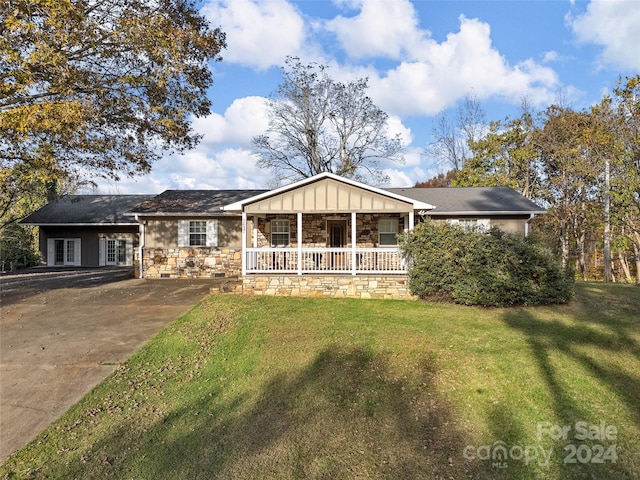 single story home with a porch and a front lawn