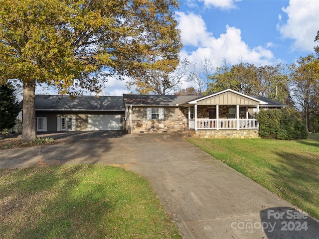 single story home with a front lawn and a porch